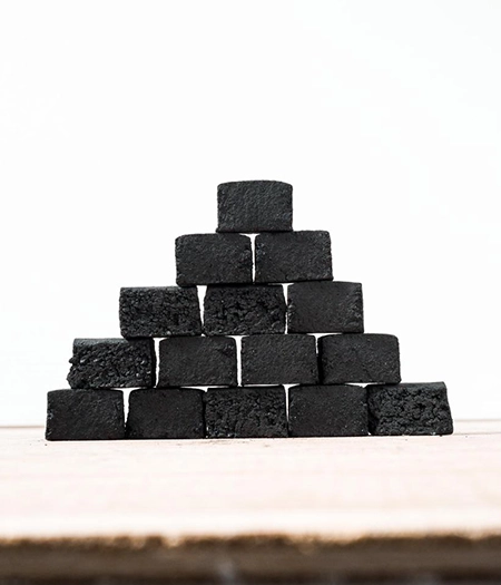 Symmetrical arrangement of square charcoal blocks ideal for smoking, barbecuing, and efficient heat management.