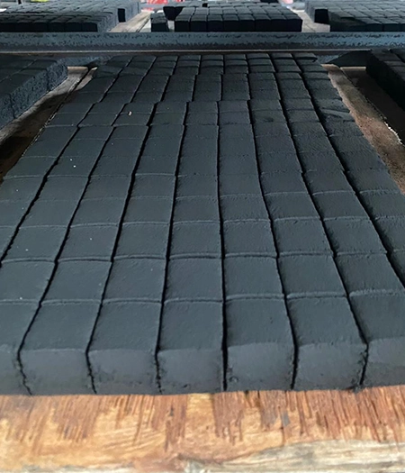 Charcoal blocks arranged on a drying rack, emphasizing premium processing and superior product quality.